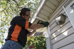 Contractor Fixing Vinyl Siding