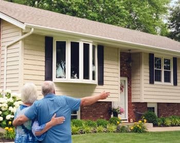 happy-couple-viewing-new-siding-on-home